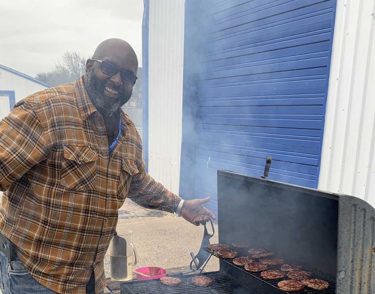 Eugene Hall, Cenikor Senior Regional Director- South Region, grilling burgers