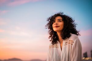 Young woman looking at view contemplating outdoors MAT Programs in Houston_ Managing Addiction Safely