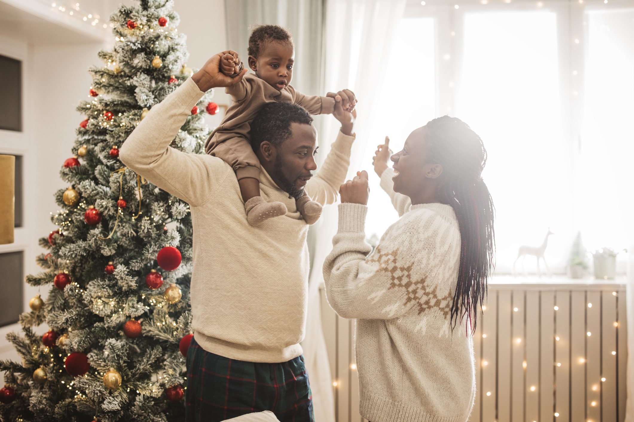 Family enjoying with child on Christmas in house 